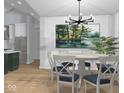 Dining room with chandelier, painting, and plant, complemented by hardwood floors at 1120 Terrace Lake Rd, Columbus, IN 47201