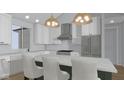 Kitchen features an island, stainless steel appliances, and stylish pendant lighting at 1120 Terrace Lake Rd, Columbus, IN 47201