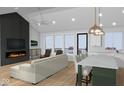 Open-concept living room with fireplace, island, and large windows offering an airy feel at 1120 Terrace Lake Rd, Columbus, IN 47201