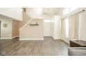 Open living room with staircase features neutral walls, wood floors, and modern decor at 1139 Maple Stream Dr, Indianapolis, IN 46217