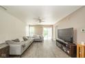 Spacious living room features an oversized sectional, wood floors, and sliding glass doors to the exterior at 1139 Maple Stream Dr, Indianapolis, IN 46217