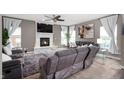 Cozy living room features a stone fireplace and plush seating at 1143 Hampton Dr, Greenwood, IN 46143