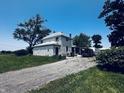 Charming two-story farmhouse featuring durable siding, a large yard, and a gravel driveway at 1170 E 400 S, Lebanon, IN 46052