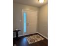 Bright foyer with hardwood flooring and decorative rug near the front door at 12328 Quarry Face Ct, Fishers, IN 46037