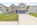 Charming two-story home with brick accents, a two-car garage, manicured lawn, and a spacious driveway at 126 Winding Brook Way, Pendleton, IN 46064