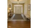 Inviting foyer with tile flooring, front door, and a console table creates a warm welcome at 12656 Cerromar Ct, Carmel, IN 46033