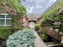 Close-up of the brick home's entrance, showing trimmed bushes and an attractive walkway to the front door at 12656 Cerromar Ct, Carmel, IN 46033