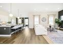 Open-concept living space with hardwood floors, large windows, and modern decor at 138 Rock Island Rd, Westfield, IN 46069