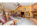 Inviting living room with a cozy brick fireplace, plush leather seating, and ample space for entertaining at 1547 Millridge Dr, Greenwood, IN 46143