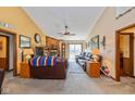 Cozy living room with brick fireplace, plush leather seating, and sliding glass doors to the backyard at 1547 Millridge Dr, Greenwood, IN 46143