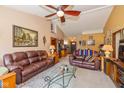 Bright living room featuring comfortable leather sofas, a glass coffee table, and ample natural light at 1547 Millridge Dr, Greenwood, IN 46143