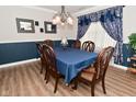 Elegant dining room featuring stylish chandelier and window with elaborate curtains at 1744 Salina Dr, Avon, IN 46123