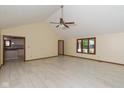 Open living room with light tile floors, vaulted ceilings, fan, and natural light at 180 Hollowview Dr, Noblesville, IN 46060