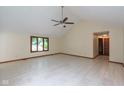 Bright living room featuring light tile floors, vaulted ceilings and a fan at 180 Hollowview Dr, Noblesville, IN 46060