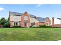 Charming two-story home with a brick facade, manicured lawn, and beautiful landscaping at 1826 Spruce Dr, Carmel, IN 46033