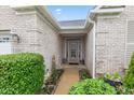 Close up of a home's entrance, showcasing the brick facade and well-kept landscaping at 18991 Round Lake Rd, Noblesville, IN 46060