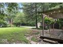 Backyard scene features a wooden deck, lush greenery, and mature trees at 20417 State Road 37 N, Noblesville, IN 46060