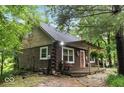 Charming log cabin home with a cozy front porch and landscaped surroundings at 20417 State Road 37 N, Noblesville, IN 46060