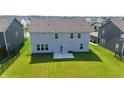 Large backyard featuring a grassy area and patio, perfect for outdoor living and entertaining at 2358 S Stonehill Way, New Palestine, IN 46163