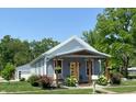 Charming exterior view featuring a welcoming front porch, colorful landscaping, and inviting curb appeal at 302 Penn St, Westfield, IN 46074