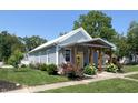 Inviting home exterior displaying manicured lawn, colorful flowerbeds, and a covered front porch at 302 Penn St, Westfield, IN 46074
