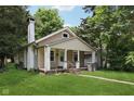 Inviting single-Gathering home with a covered porch, classic design, and a well-manicured front yard at 3028 Hovey St, Indianapolis, IN 46218