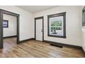 Bright living room features new laminate flooring, fresh paint, and a view to the outside at 3028 Hovey St, Indianapolis, IN 46218