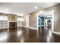 Spacious living room with hardwood floors, fireplace, and ample natural light at 33 N Webster Ave, Indianapolis, IN 46219