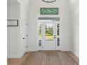 Bright entryway featuring beautiful natural light and warm wood flooring, creating a welcoming ambiance at 3365 Riverside Dr, Columbus, IN 47203