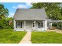Inviting home featuring a covered porch, neat landscaping, and traditional architectural details at 379 N Marion St, Morgantown, IN 46160