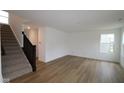 Bright living room featuring hardwood floors, neutral walls and large windows at 3917 Highcrest Rd, Indianapolis, IN 46239