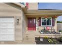 The entrance features seasonal decor, a welcoming bench, and a well-manicured garden at 4605 Clairmont Dr, Columbus, IN 47203