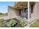 Charming front porch with decorative plants and cozy seating area at 4605 Clairmont Dr, Columbus, IN 47203