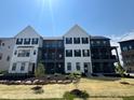 Beautiful new townhome exterior featuring professional landscaping and craftsman style architecture at 473 Mariposa Trl, Carmel, IN 46032