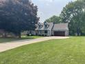 Exterior view of the home with a long driveway and mature trees at 530 Denny Dr, Mooresville, IN 46158