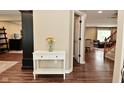 Entryway with wood floors and a white console table decorated with a vase of flowers at 5456 Reston Dr, Plainfield, IN 46168