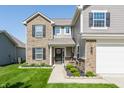 Charming two-story home with a welcoming entrance, brick accents, and professional landscaping at 5794 Cherrywood Ln, McCordsville, IN 46055
