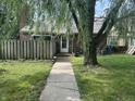 A quaint front yard showcases a walkway leading to the front door, with a mature tree enhancing the curb appeal at 5941 Deerwood Ct, Indianapolis, IN 46254