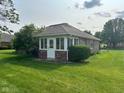 Enclosed patio with brick construction, screened windows, and a door leading to the yard at 641 S Grant St, Brownsburg, IN 46112