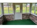 Bright sunroom featuring brick walls, ample windows, and a door to the outside at 641 S Grant St, Brownsburg, IN 46112