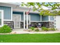 Inviting front porch with stone accents and comfortable seating, perfect for enjoying the outdoors at 655 N Sobota Way, Trafalgar, IN 46181