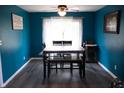 Inviting dining room with wood floors, bright blue walls, and a ceiling fan at 6801 Shalimar Ct, Indianapolis, IN 46214