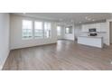 Open concept living area with wood-look floors, recessed lighting, and abundant natural light at 7151 Firestone Rd, Whitestown, IN 46052