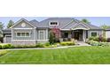 Charming home with lush green lawn, professional landscaping and a three-car garage at 780 Chatham Hills Blvd, Westfield, IN 46074