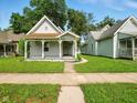 Well-manicured lawn and charming single-story home with a welcoming front porch at 813 Cottage Ave, Columbus, IN 47201