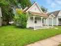Cozy single-story home with a front porch and mature trees in a well-kept yard at 813 Cottage Ave, Columbus, IN 47201