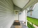 The covered front porch welcomes guests to this charming residence at 813 Cottage Ave, Columbus, IN 47201