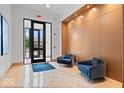 Comfortable lobby area with blue armchairs and a welcome mat in a luxury building at 855 N East N St # 104-B, Indianapolis, IN 46202