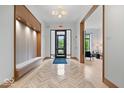 Inviting lobby features wood floors in a herringbone pattern, a seating bench, and bright lighting at 855 N East N St # 104-B, Indianapolis, IN 46202