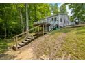 Charming home on a wooded lot, featuring multiple decks and stairs, perfect for nature lovers and outdoor living at 8576 Riser Dr, , IN 46164